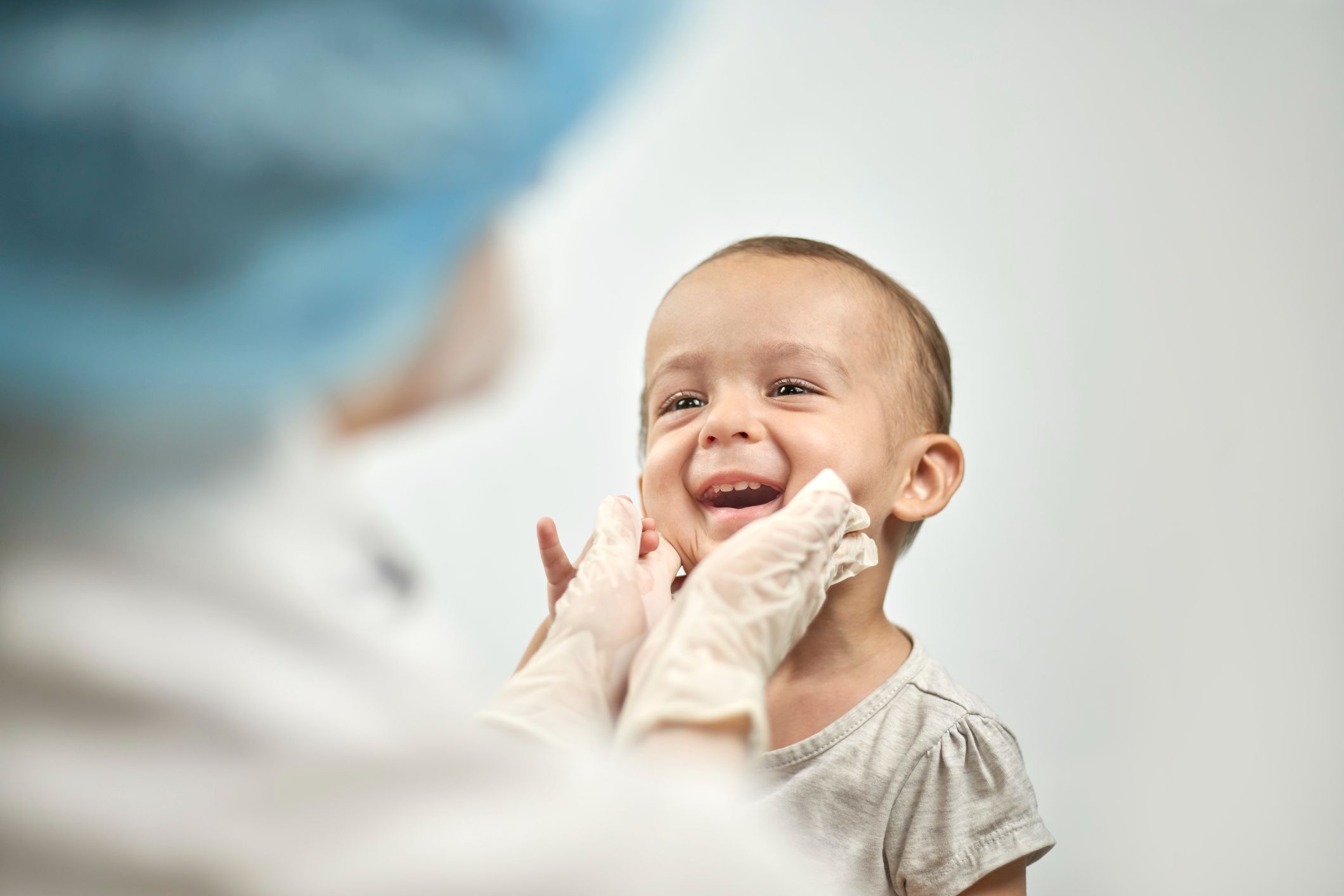 Pediatric Dentistry showing Dr. examining child's cheeks