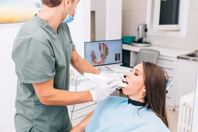 Dental Exam dentist imaging a young woman's teeth