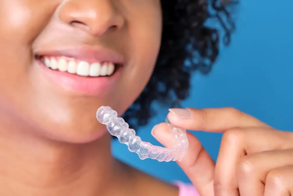 Fluoride treatments with Girl holding a fluoride treatment tray